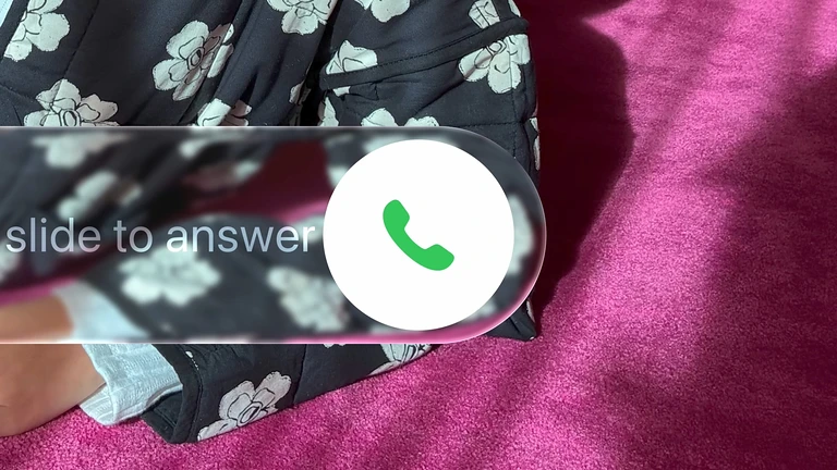 Liquid Glass slide-to-answer control over a patterned iPhone Lock Screen